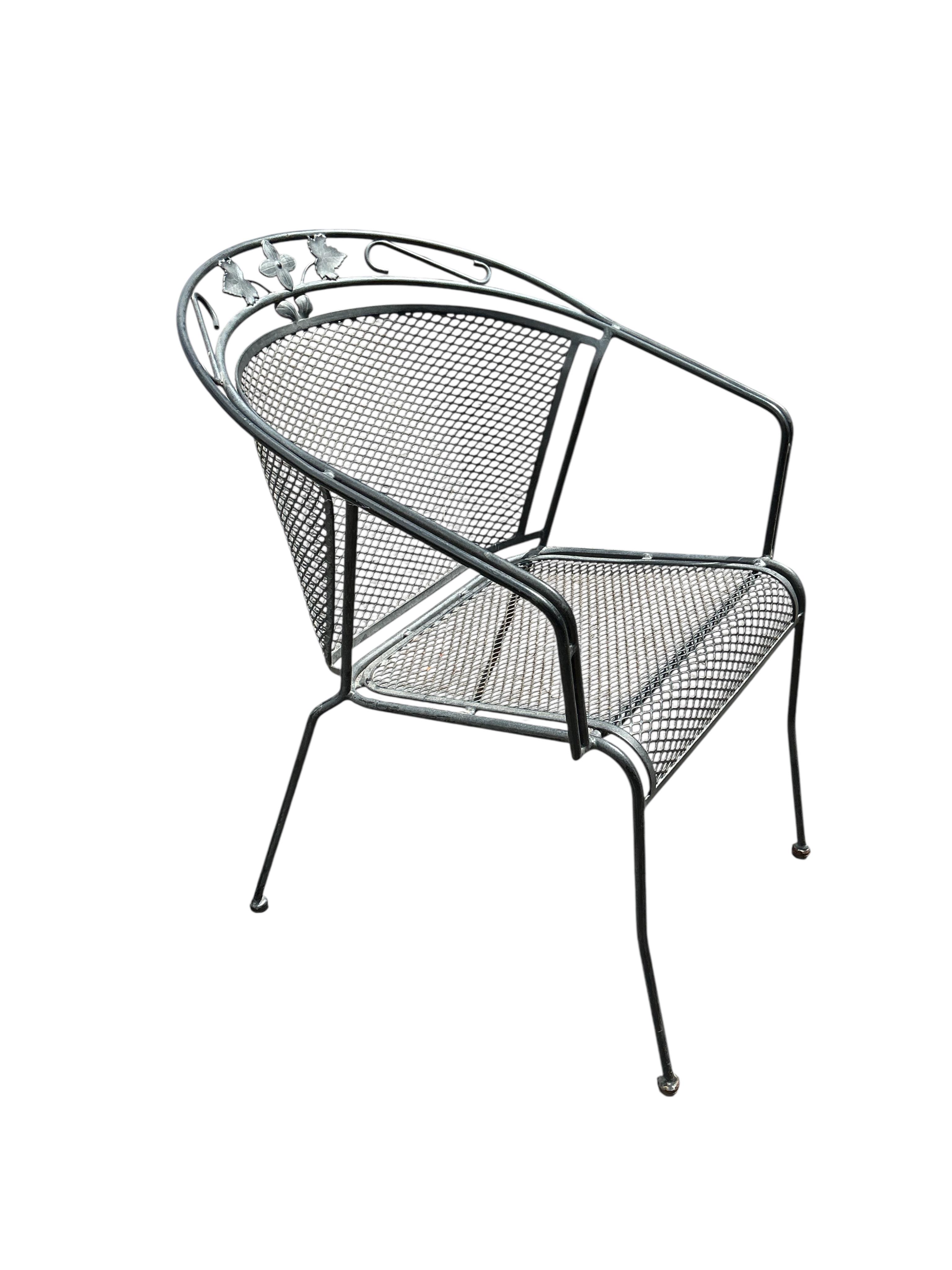 A wrought iron garden bench and ten matching garden chairs